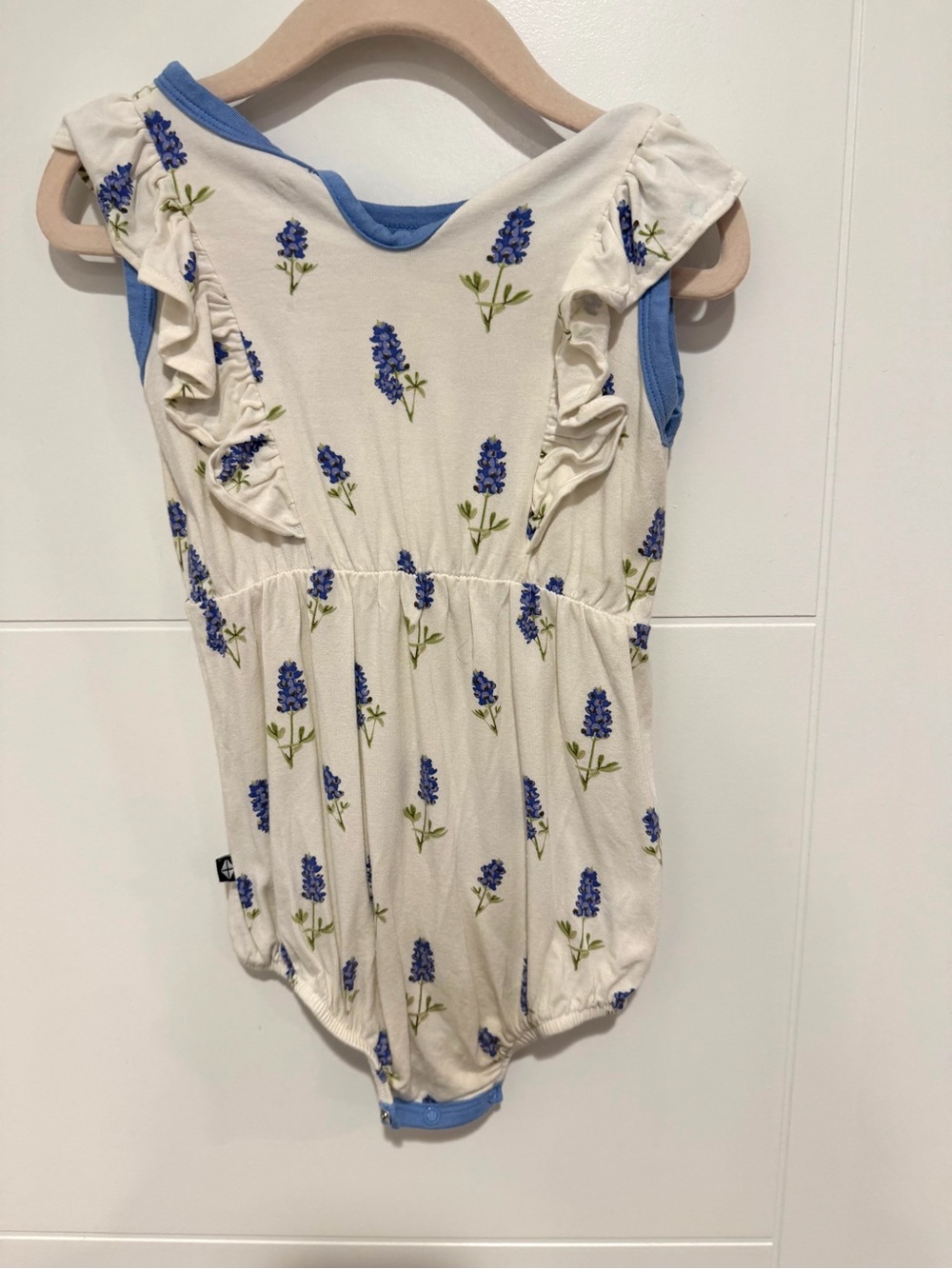 Kyte BABY Cream Romper with Light Blue Trim and Floral Accent